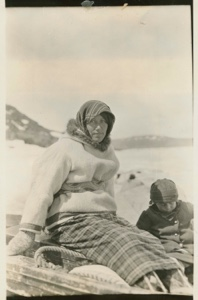 Image of Herbert Decker's wife and child in boat on sledge